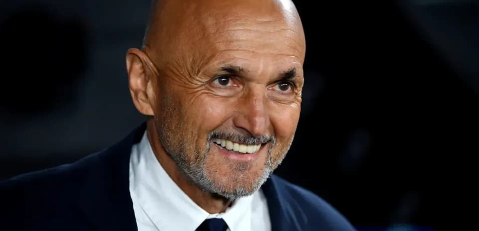Bald man in suit smiling at event
