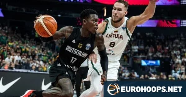 Germany player dribbling past Lithuania defender during match