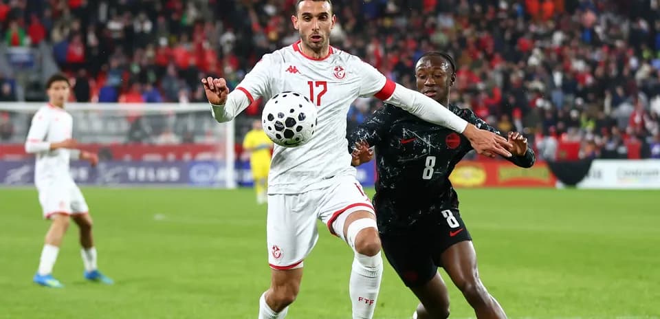 Tunisian player controlling the ball during match