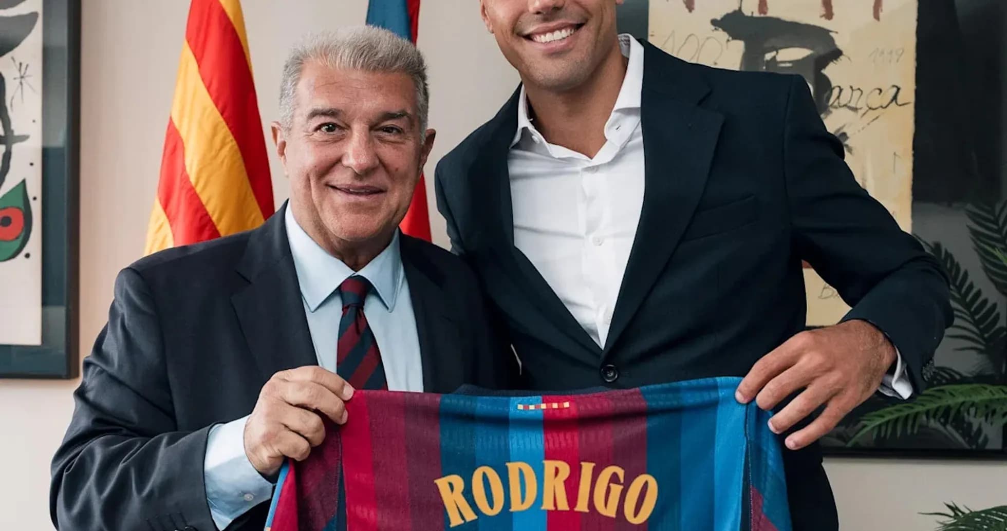Rodrigo holding Barcelona jersey with president