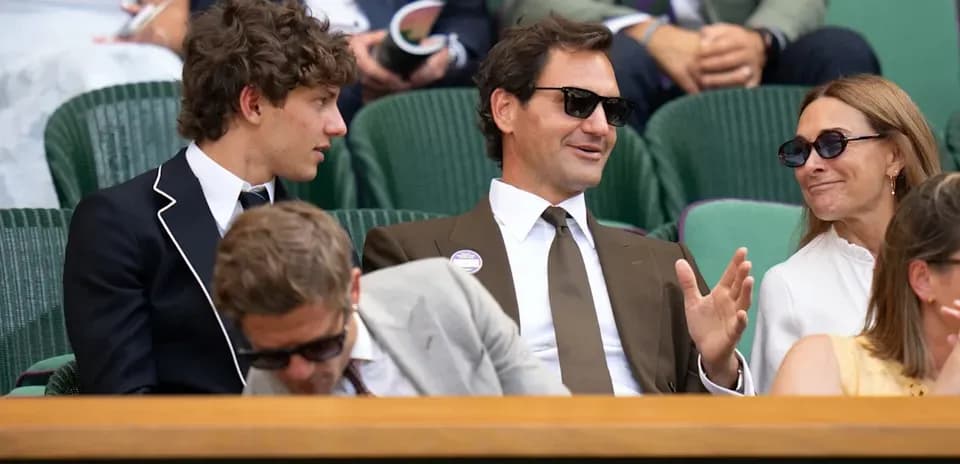 People seated at Wimbledon, engaging in conversation