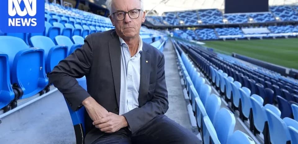 Man sitting in empty stadium seats