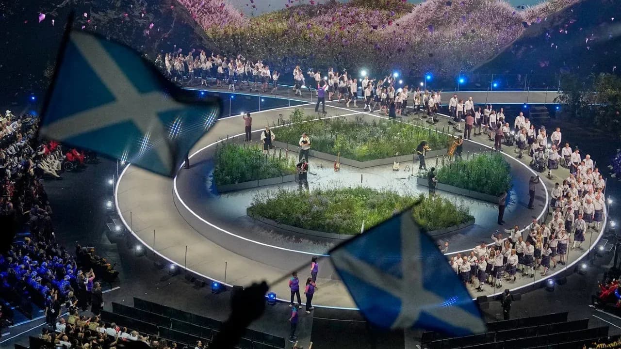 Performers on stage during cultural event with flags