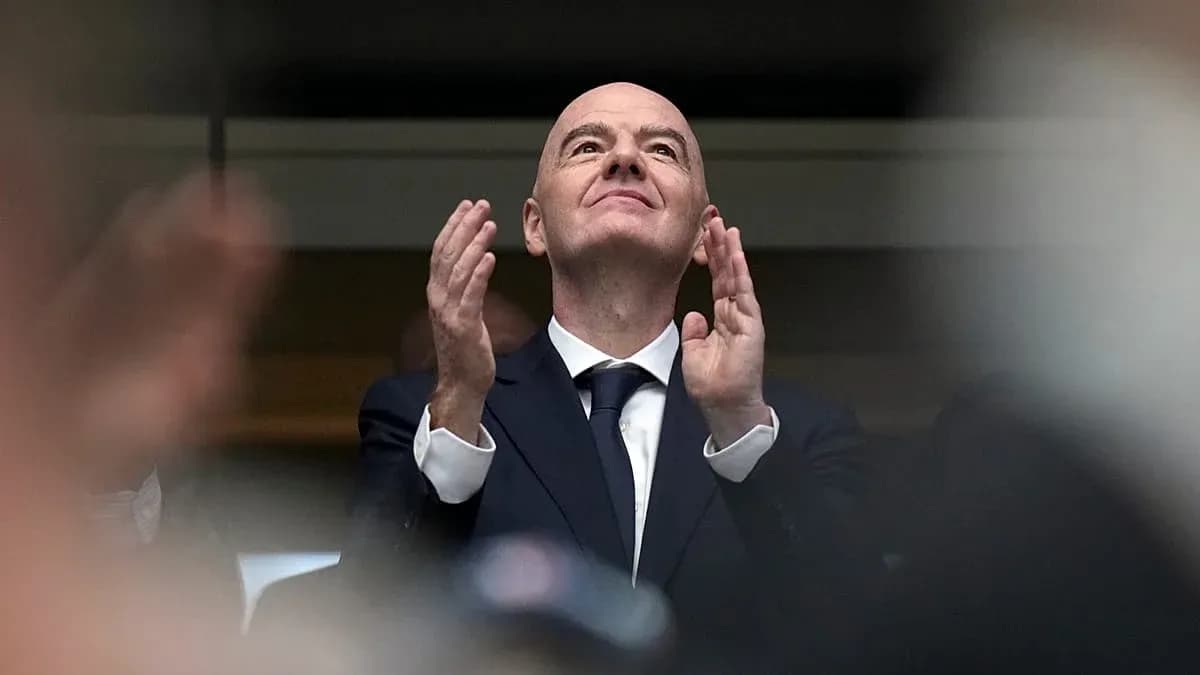 Man in suit applauding at an event