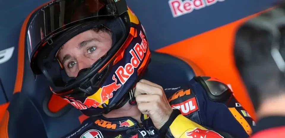 Motorsport rider preparing with helmet in garage