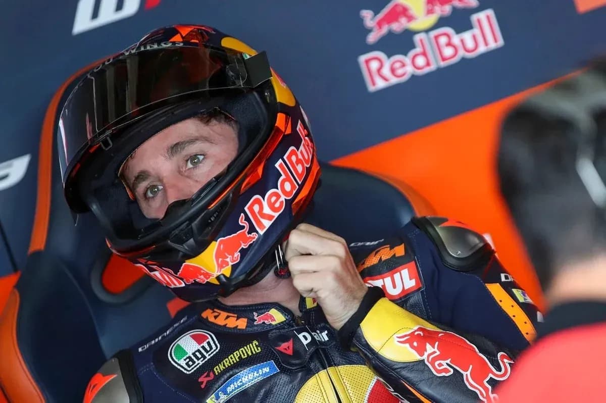 Motorsport rider preparing with helmet in garage