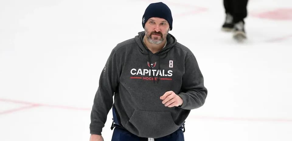 Hockey coach on ice during practice session