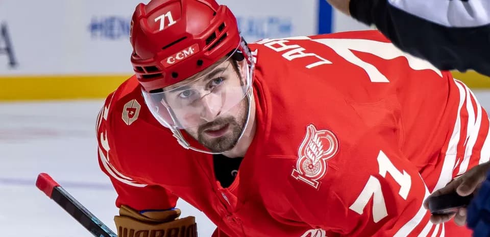 Hockey player in red jersey during game action