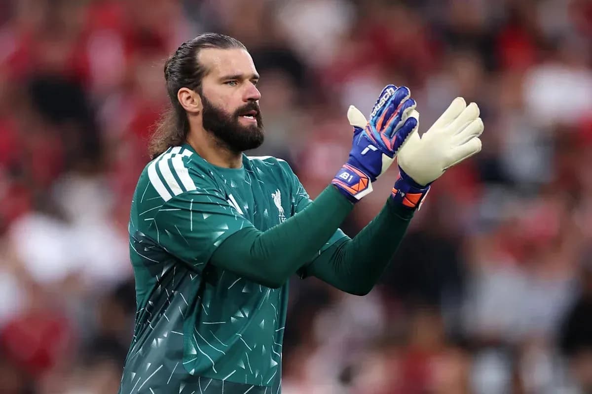 Goalkeeper in green kit clapping during match