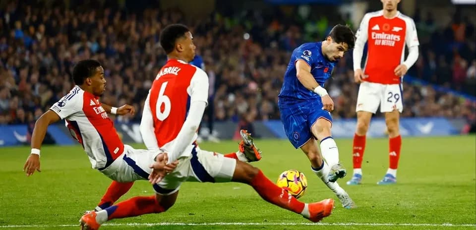 Chelsea player attempting to shoot during match against Arsenal