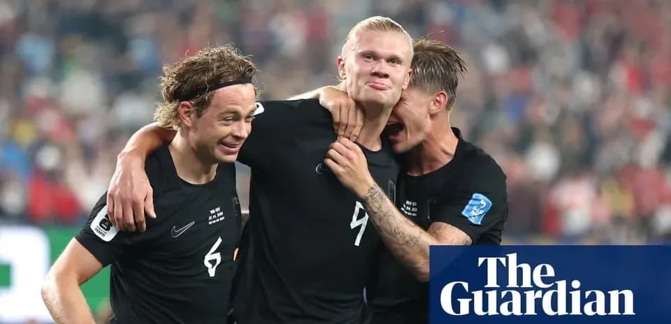Three players celebrating a goal together