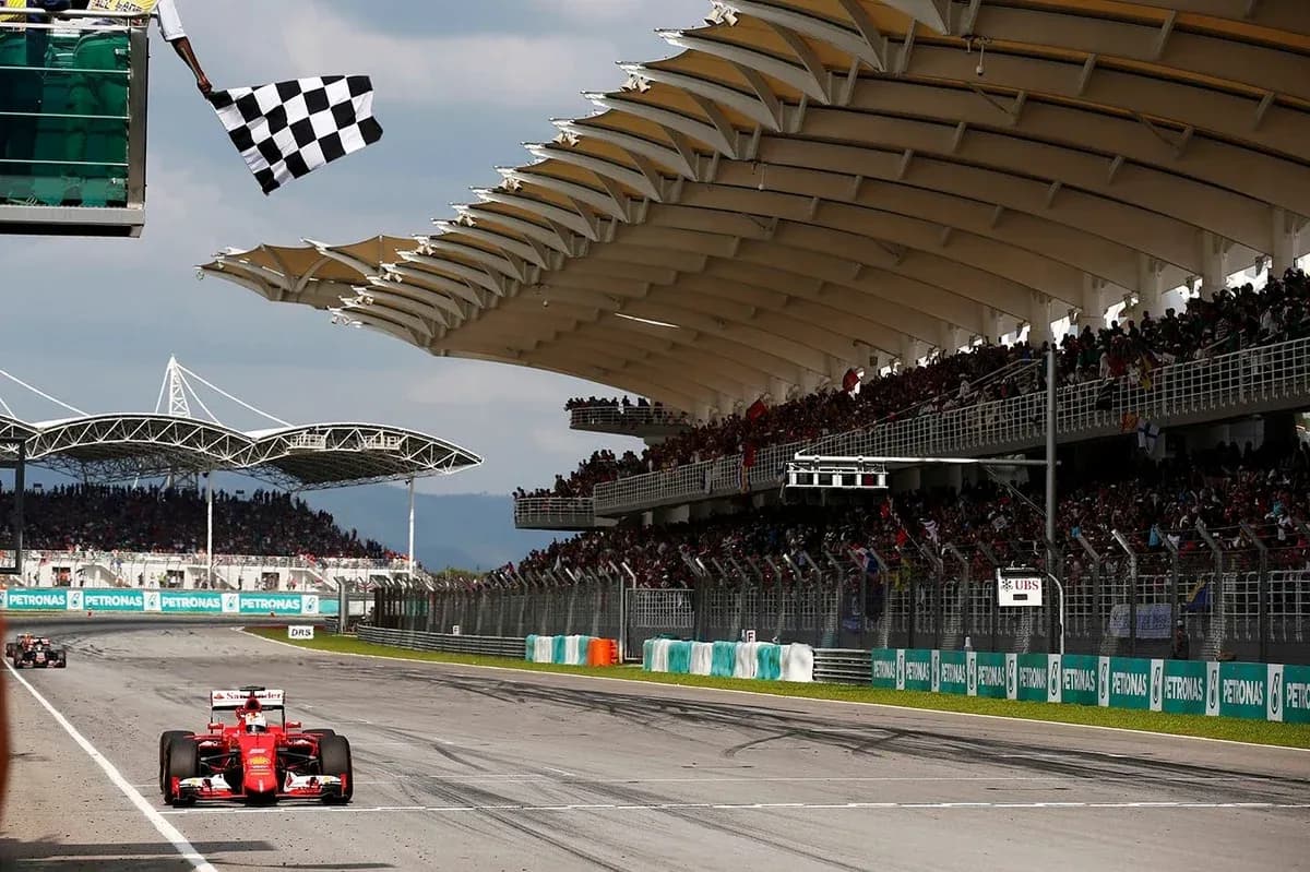 Formula 1 car crossing finish line with checkered flag Formula 1 car crossing finish line with checkered flag