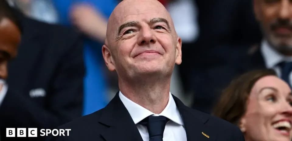 FIFA president smiling in a crowded venue