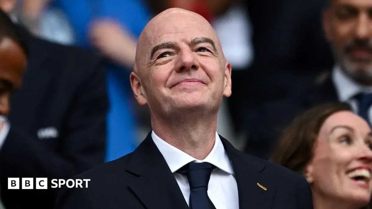 FIFA president smiling in a crowded venue