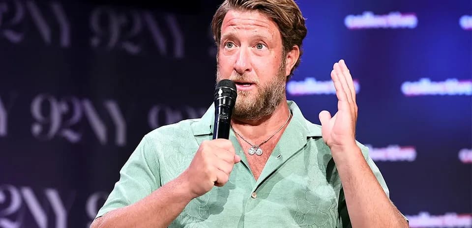 Man speaking into microphone at event