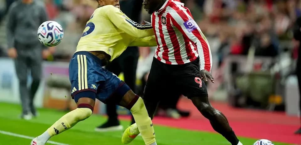 Two players competing for the ball during match
