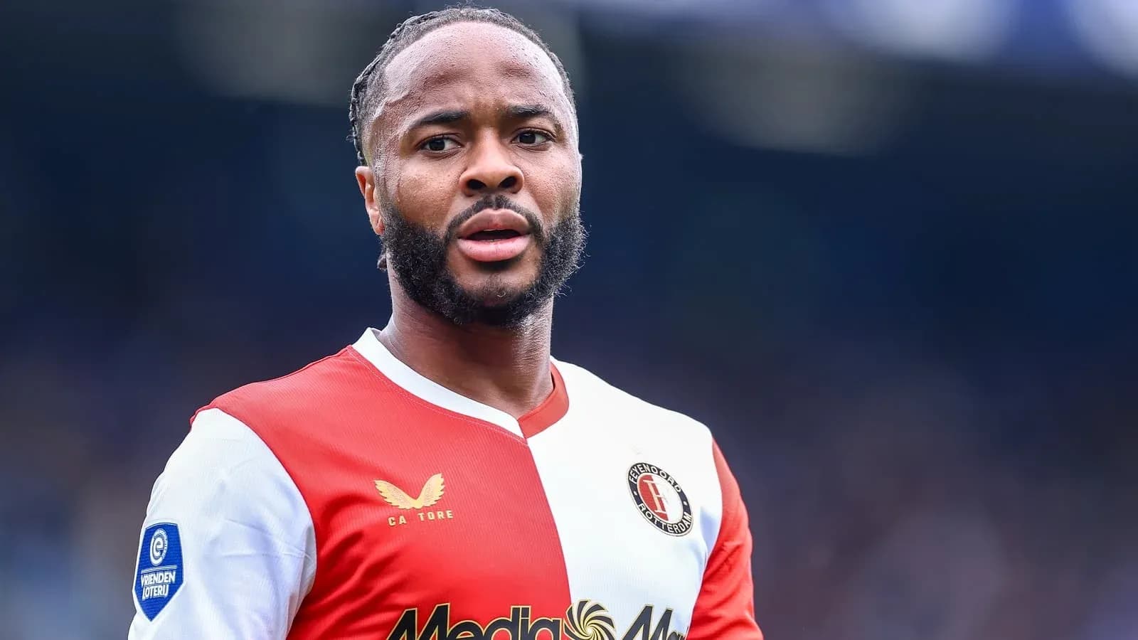 Feyenoord player in red and white jersey on field