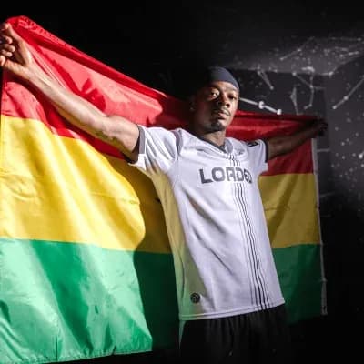 Player holding Bolivian flag while posing