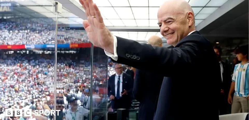 Person waving from a VIP box at stadium