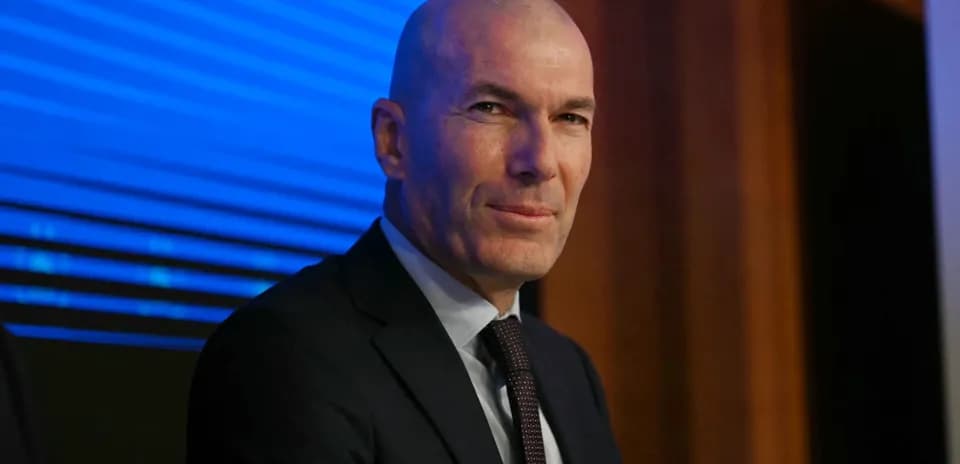 Bald man in suit during press conference