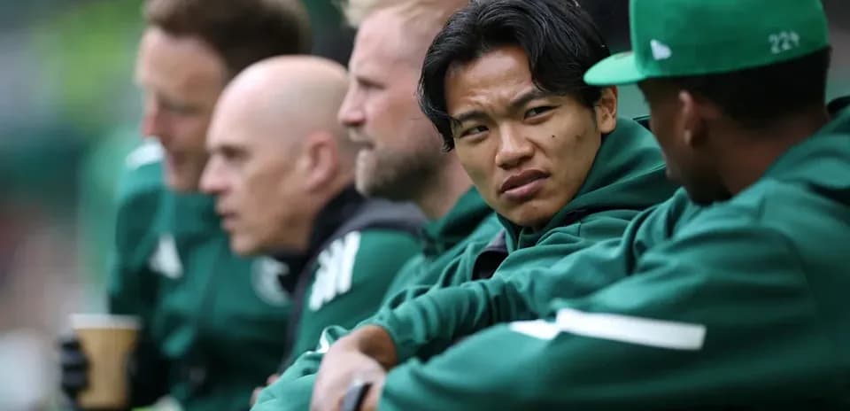 Players seated on bench during match discussion