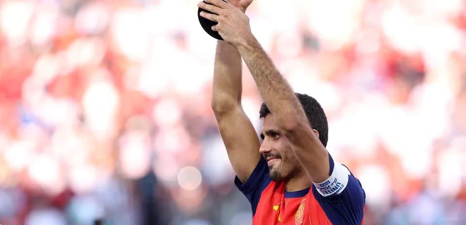 Futbolchi mukofotni ko'tarib turib, maydonda