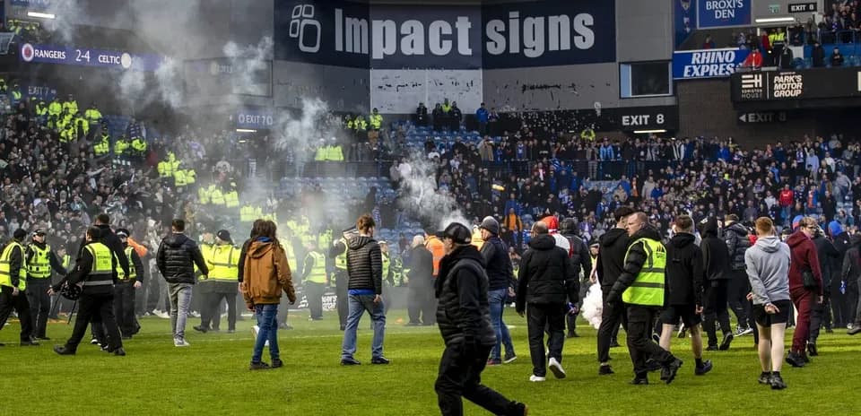 Fans and security during post-match crowd disturbance