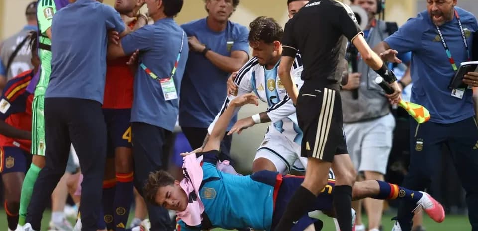 Players and staff involved in a scuffle on the pitch
