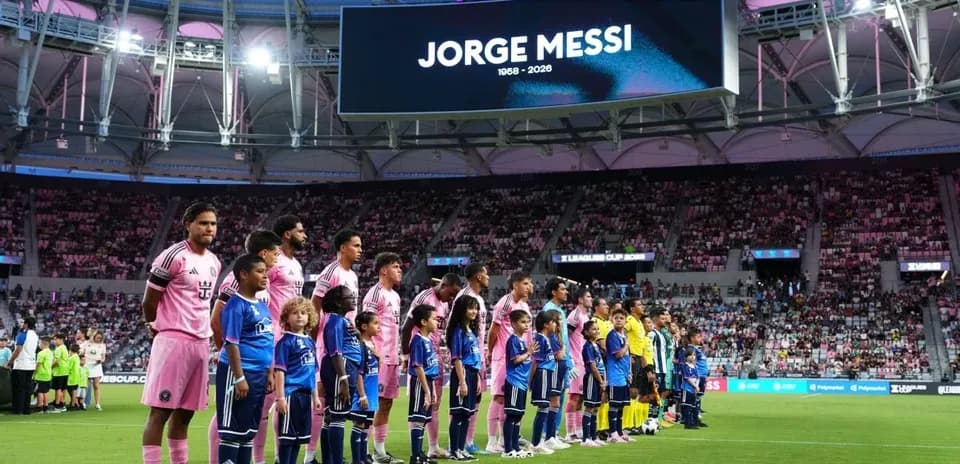 Players and children lined up before match at stadium