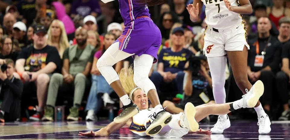 Player falling on court during basketball game action