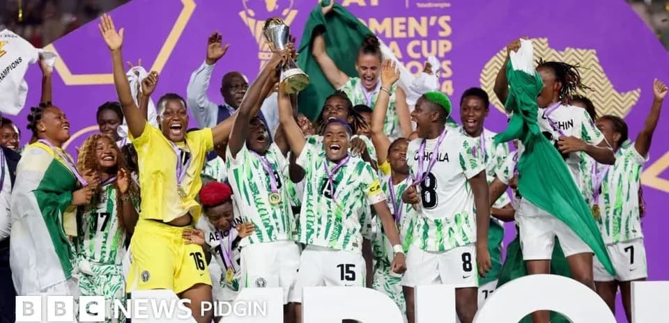 Nigeria women's team celebrating AFCON victory with trophy