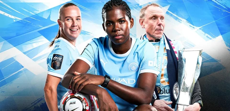 Manchester City players and coach posing with trophy
