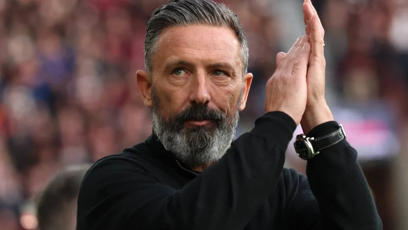 Coach applauding during a football match