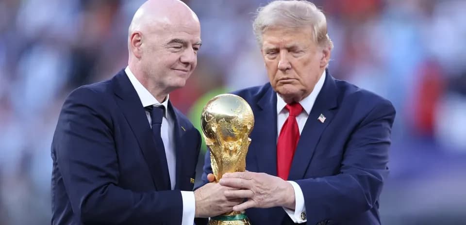 Two men holding the FIFA World Cup trophy