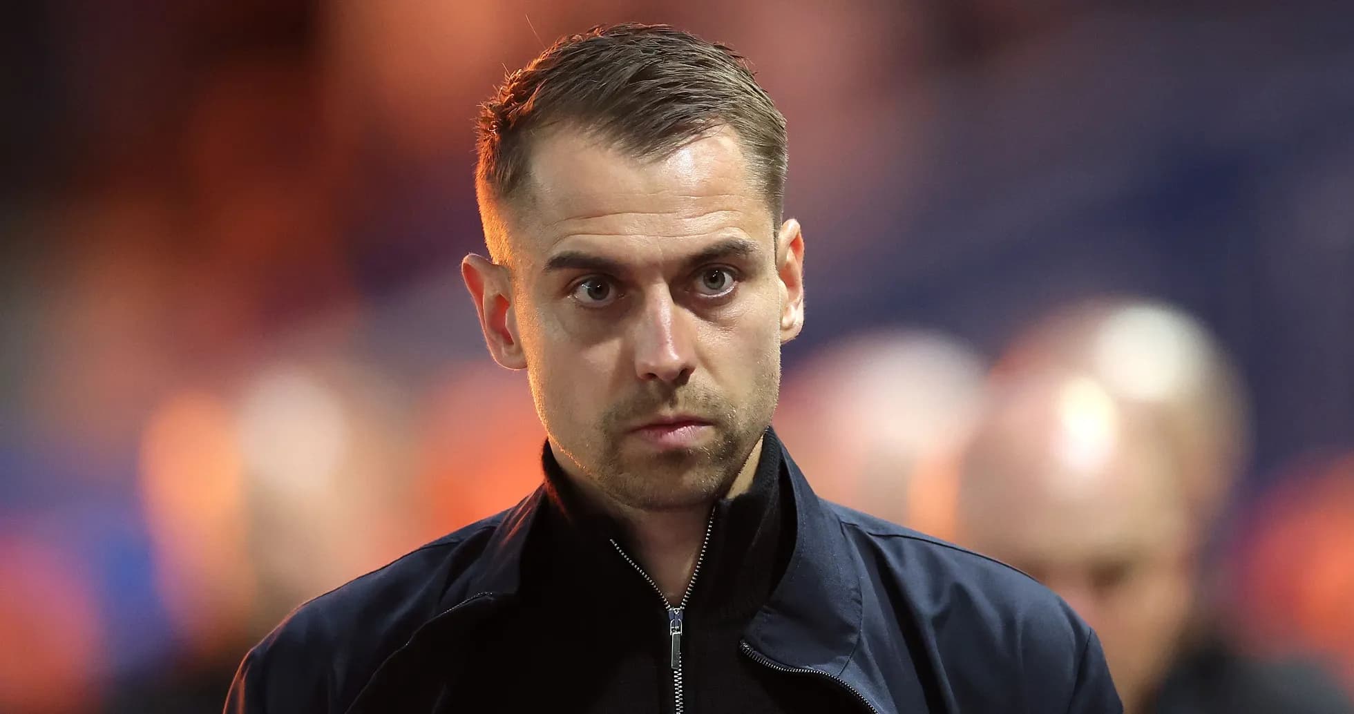 Coach walking towards the sidelines during match