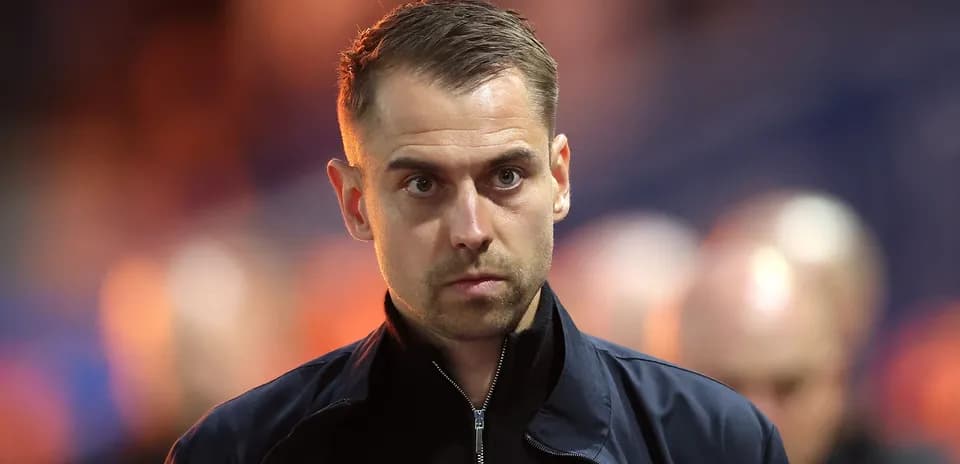 Coach walking towards the sidelines during match