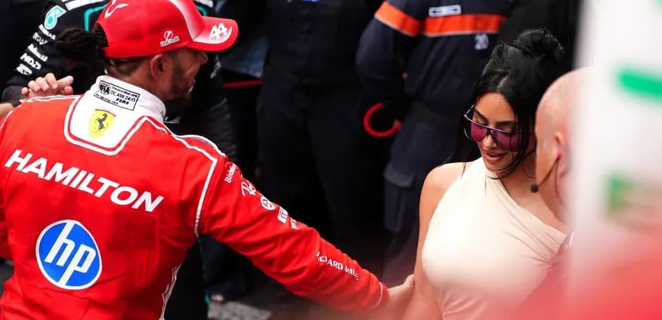 Formula 1 driver interacting with a woman at event