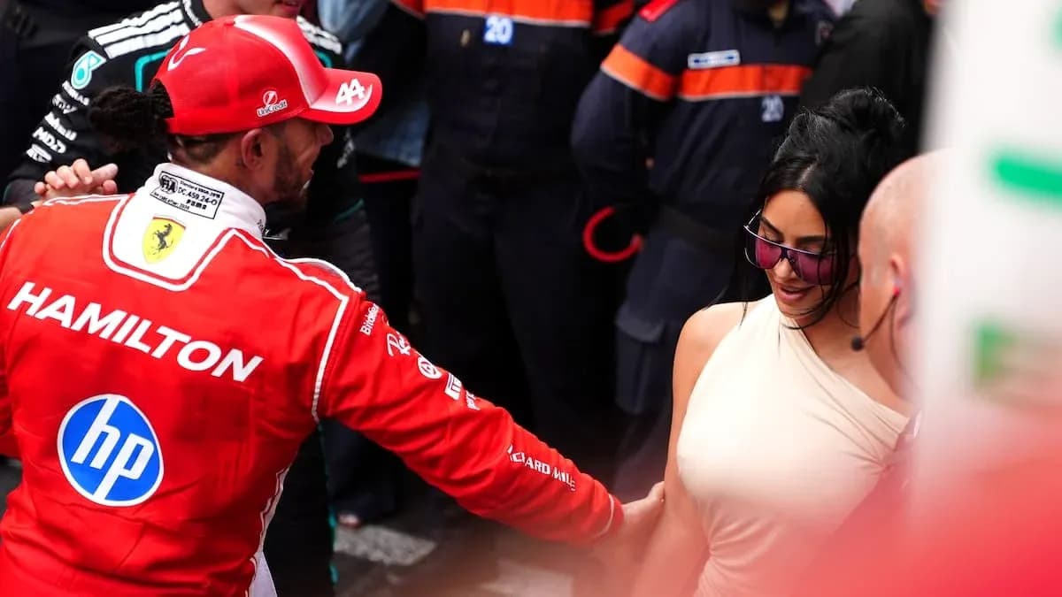 Formula 1 driver interacting with a woman at event