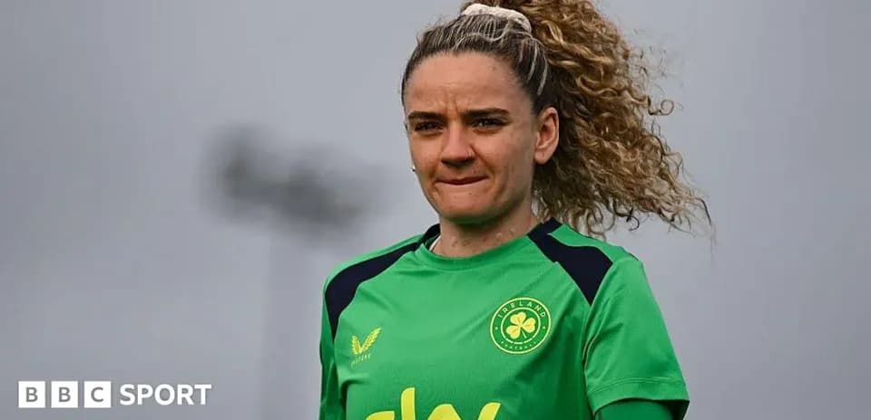 Goalkeeper in green kit preparing for training session