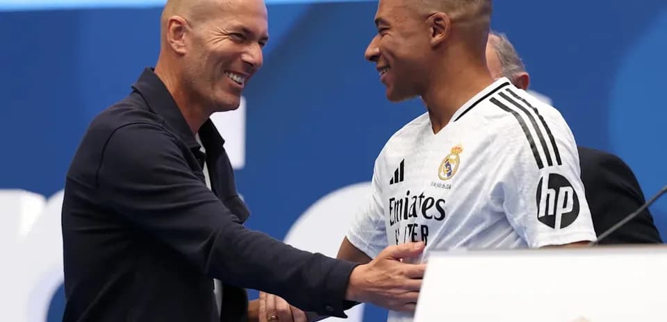 Zinedine Zidane and player shaking hands at event
