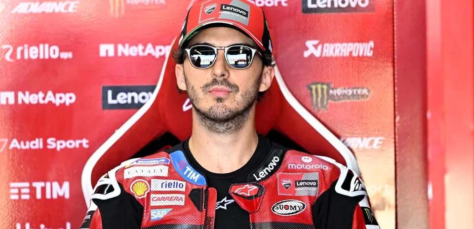 Rider in sunglasses seated in pit area