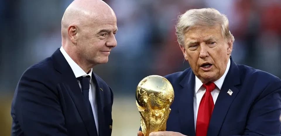 Two men exchanging the FIFA World Cup trophy