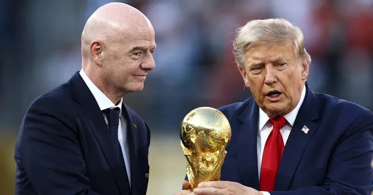 Two men exchanging the FIFA World Cup trophy