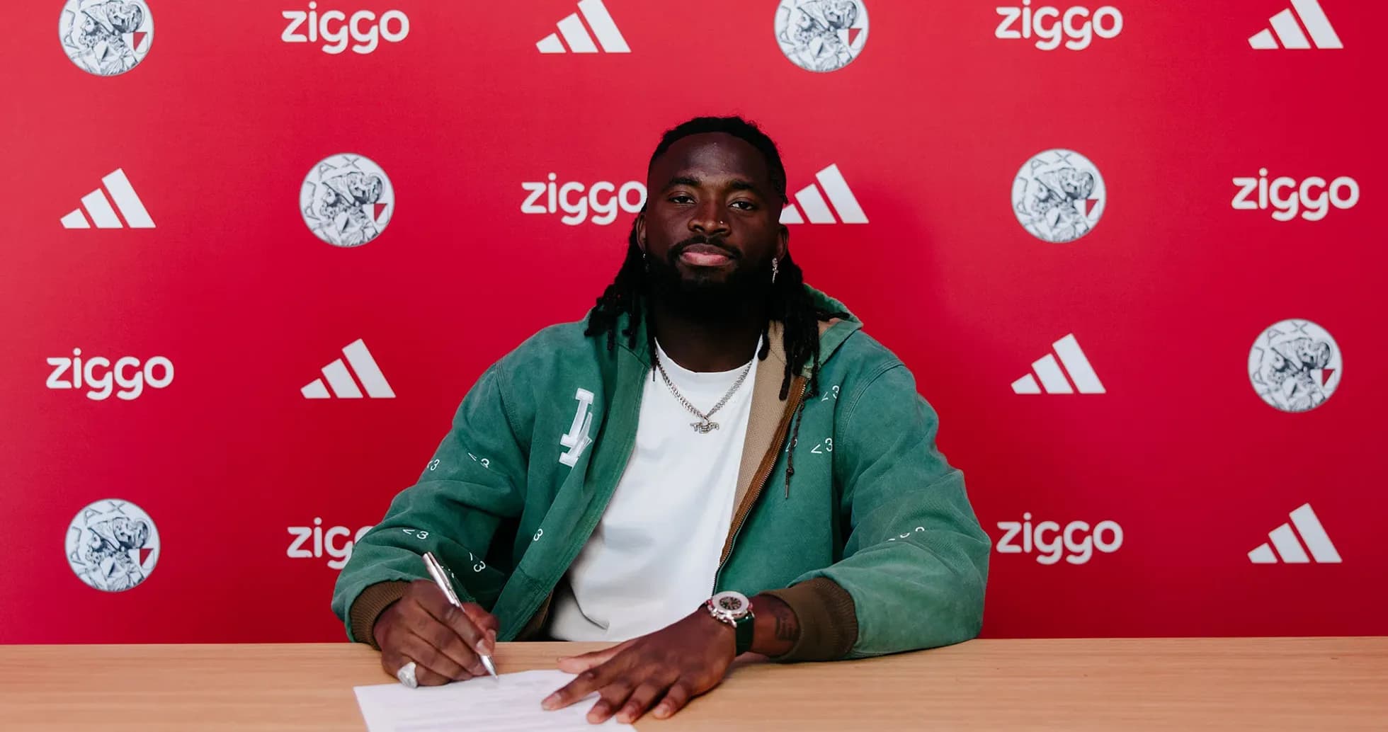 Futbolchi shartnoma imzolayotgani bilan suratga olingan