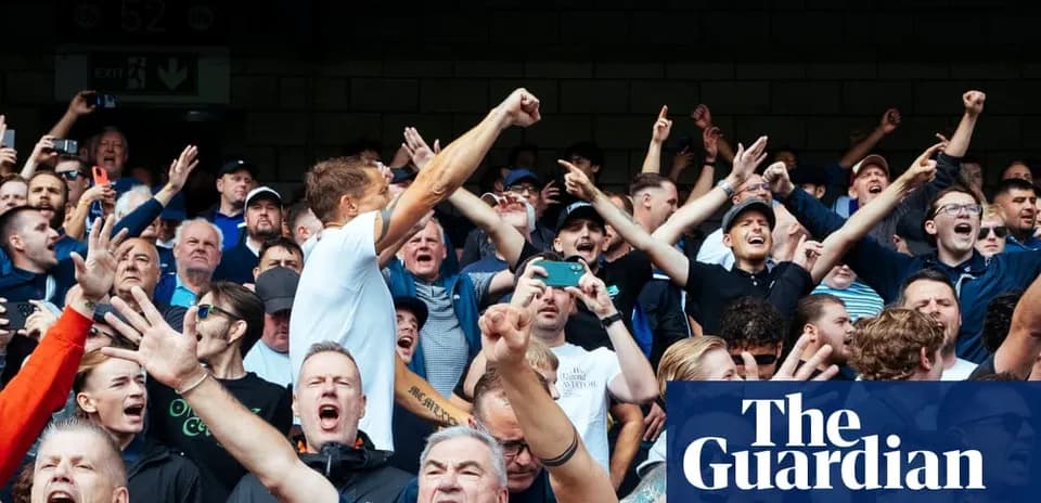 Fan crowd cheering energetically during sports event