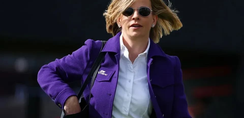 Woman in purple jacket walking with a bag