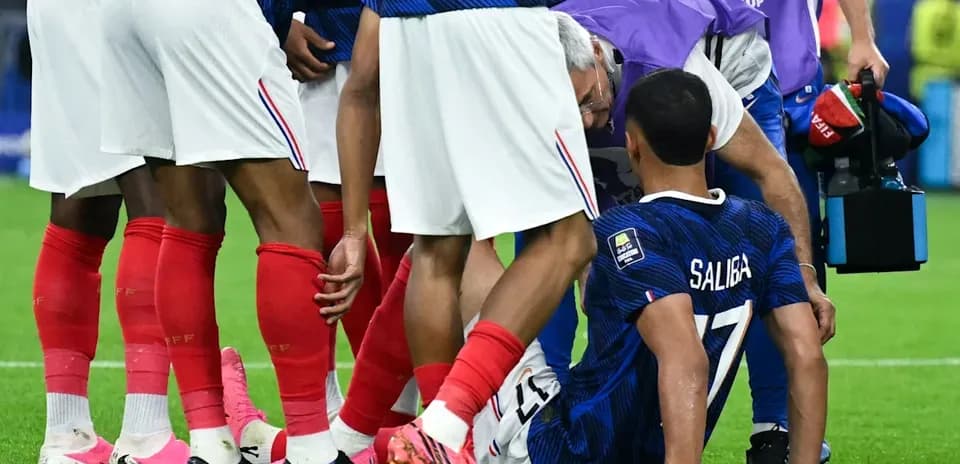 Saliba receiving medical attention from teammates