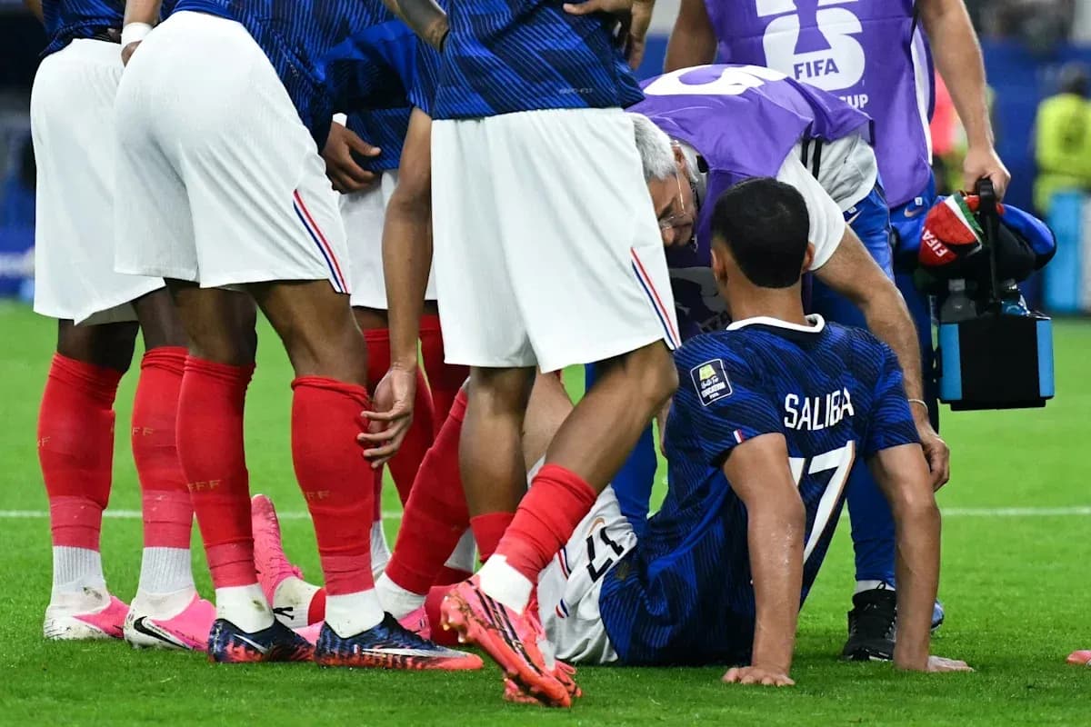 Saliba receiving medical attention from teammates