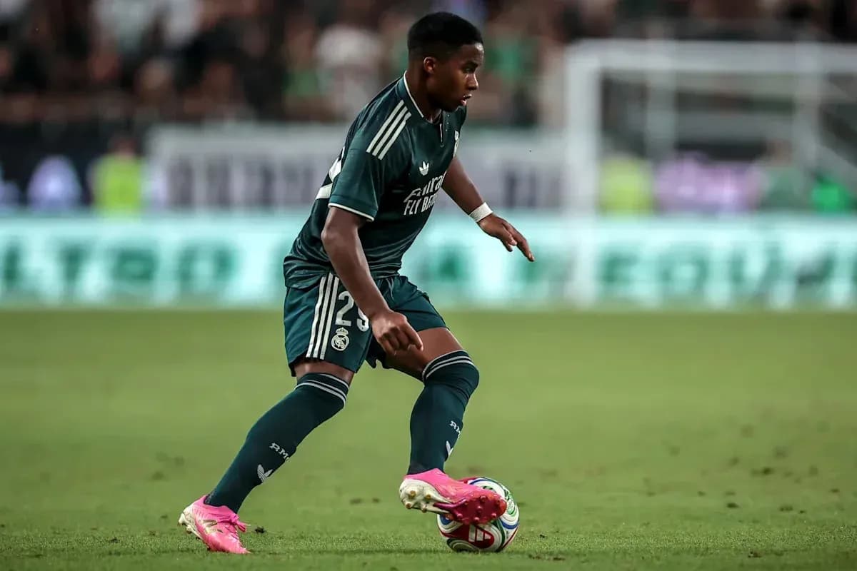 Futbolchi Real Madrid formasida to'p bilan harakatda