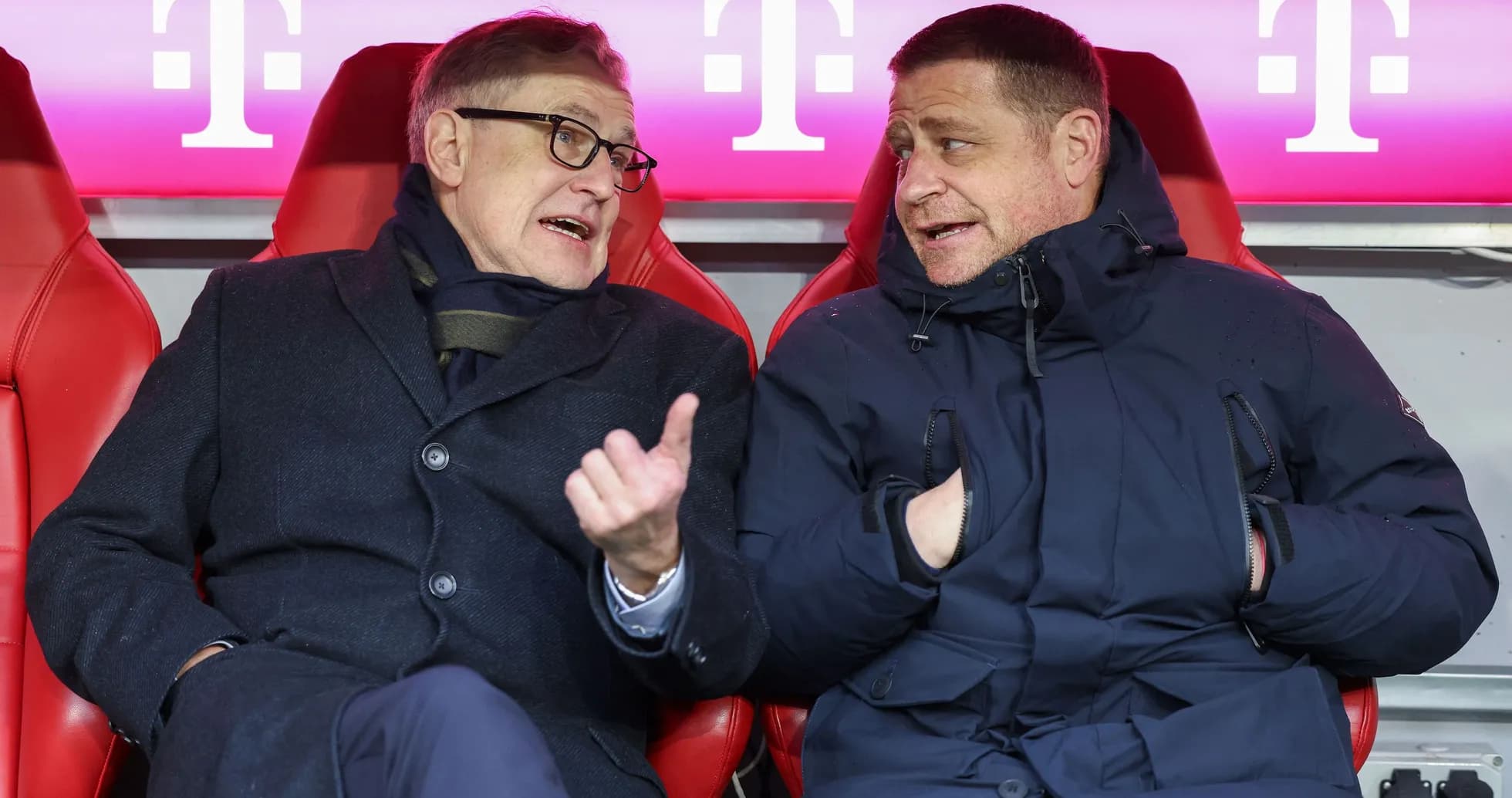 Two men chatting in team bench seats